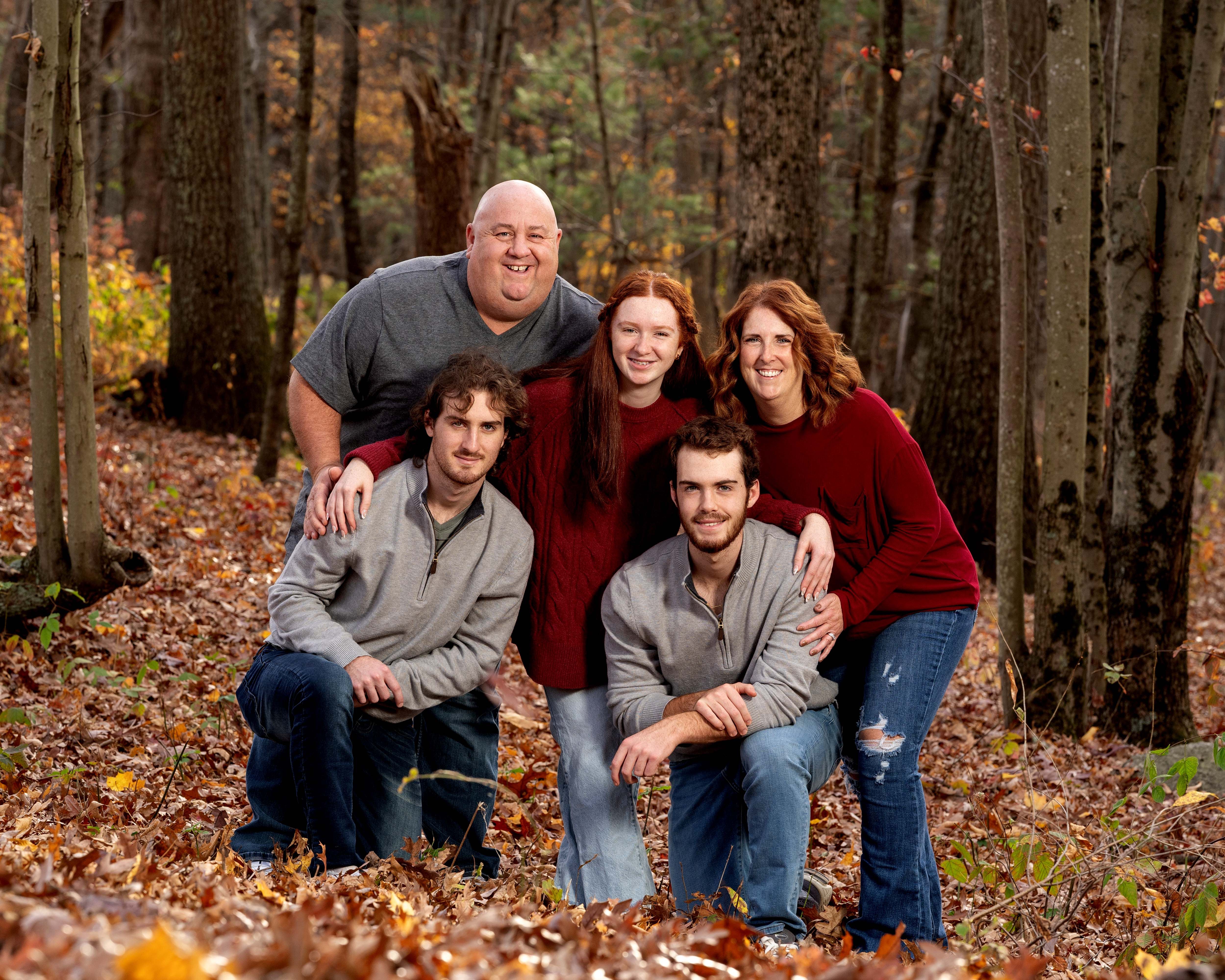 A family portrait surrounded by the colors of fall in New England