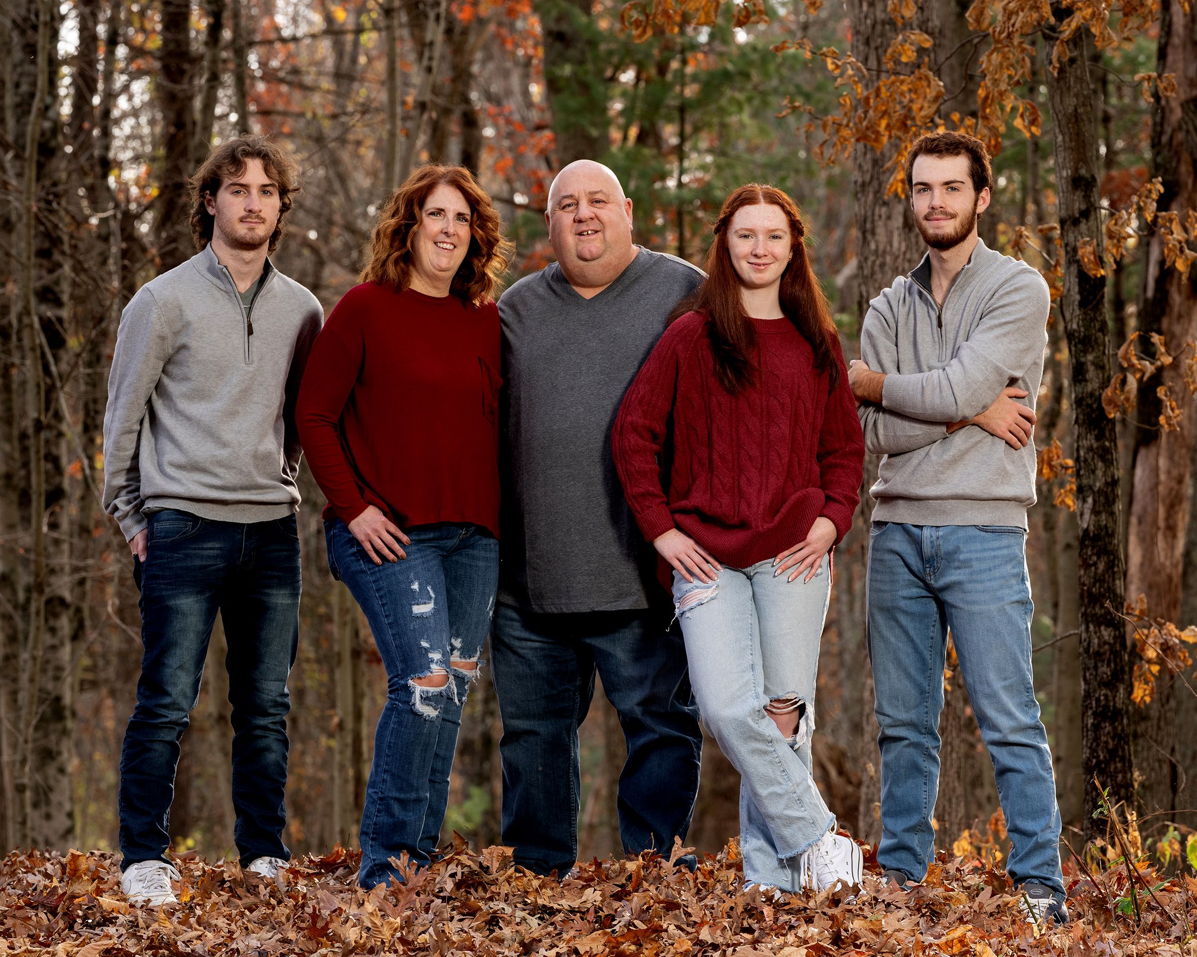 A relaxed family portrait in the autumn woods